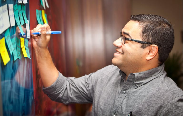 Man writing on thought board